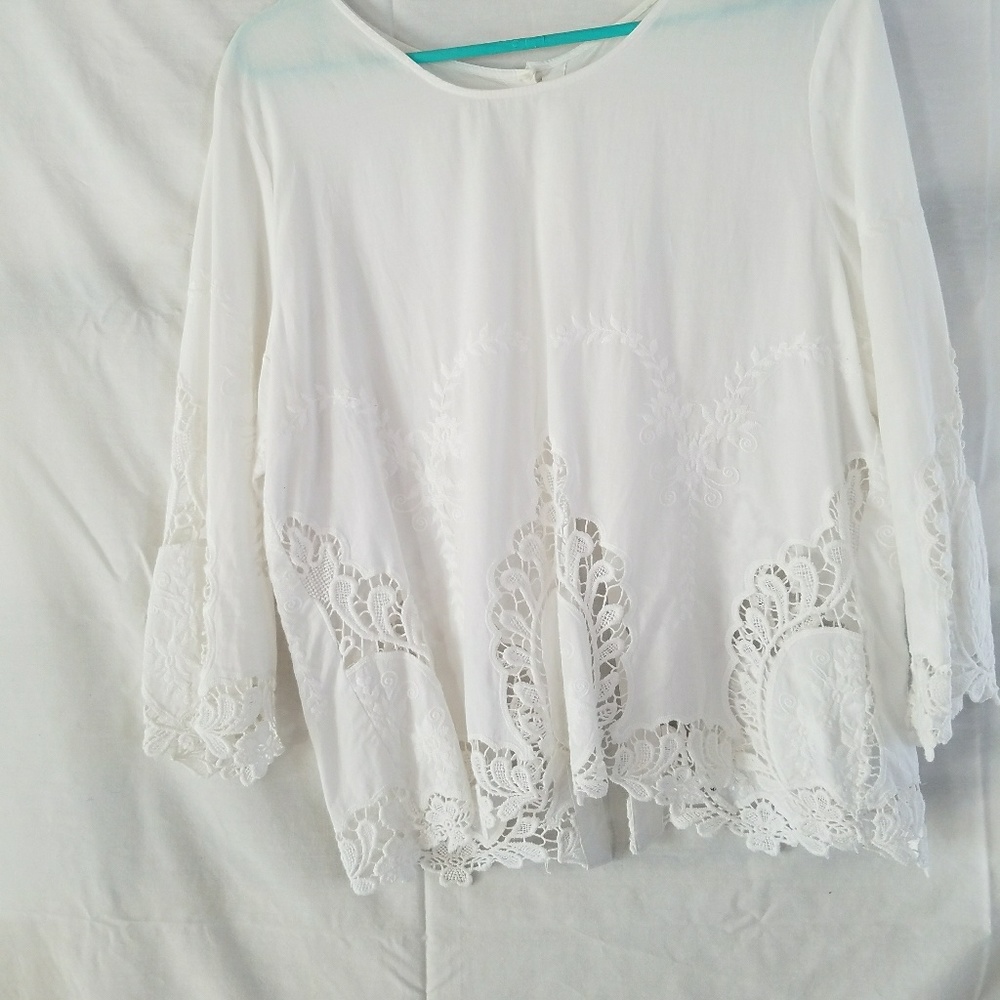 White blouse w/buttons in the back.